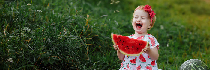 Child eating a watermelon.