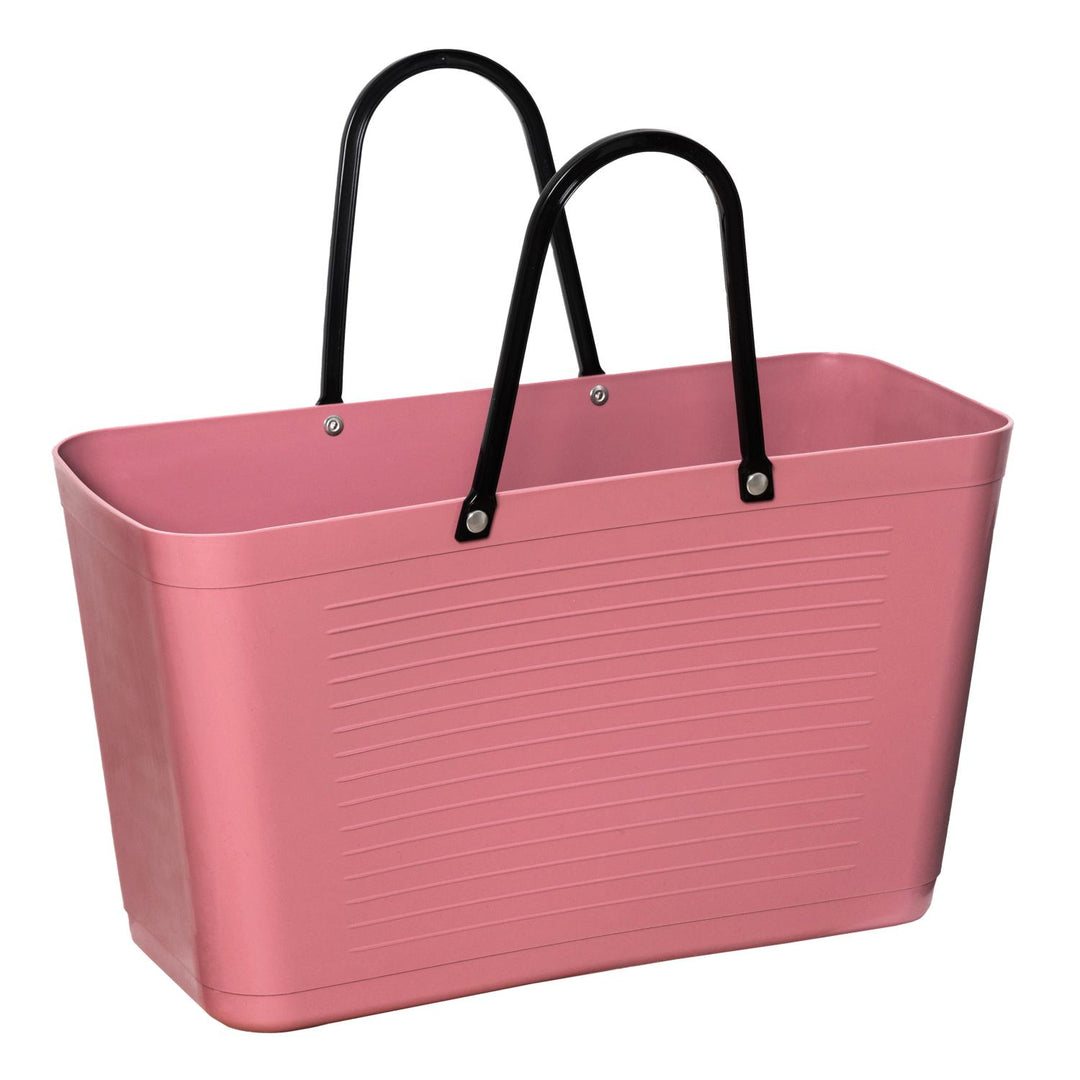 Pink metal tote bag with black handles.