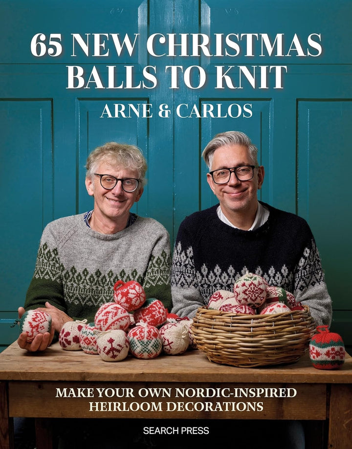 Cover of book that reads: 65 New Christmas Balls to Knit. Arne & Carlos. Make your own nordic inspired heirloom decorations. Arne and Carlos are smiling and wearing nordic sweaters with a pile of Christmas balls. in front of them. 