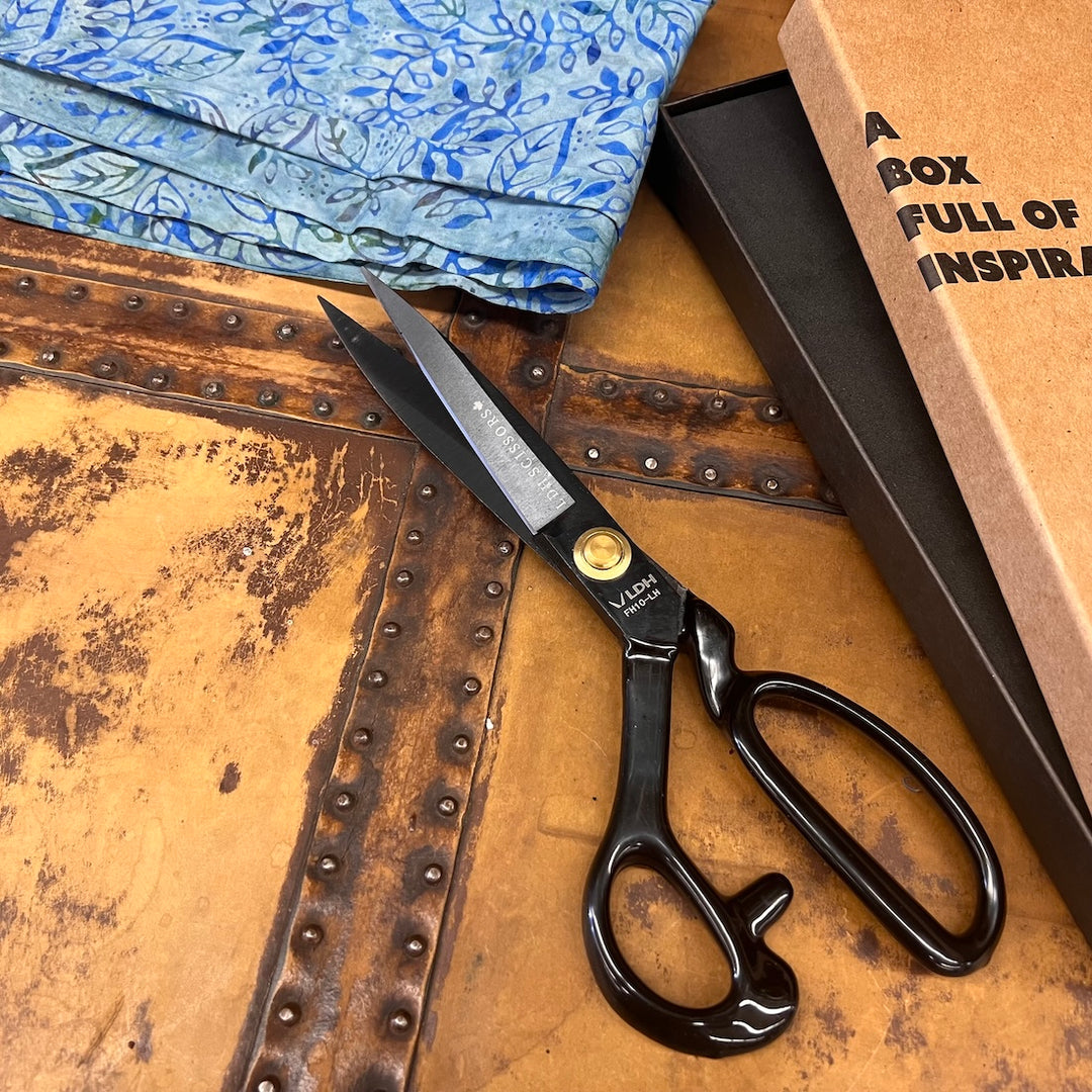 Black heavy duty fabric succors with rubber coated handles. The box they come in is to the right and says, "A box full of inspiration."