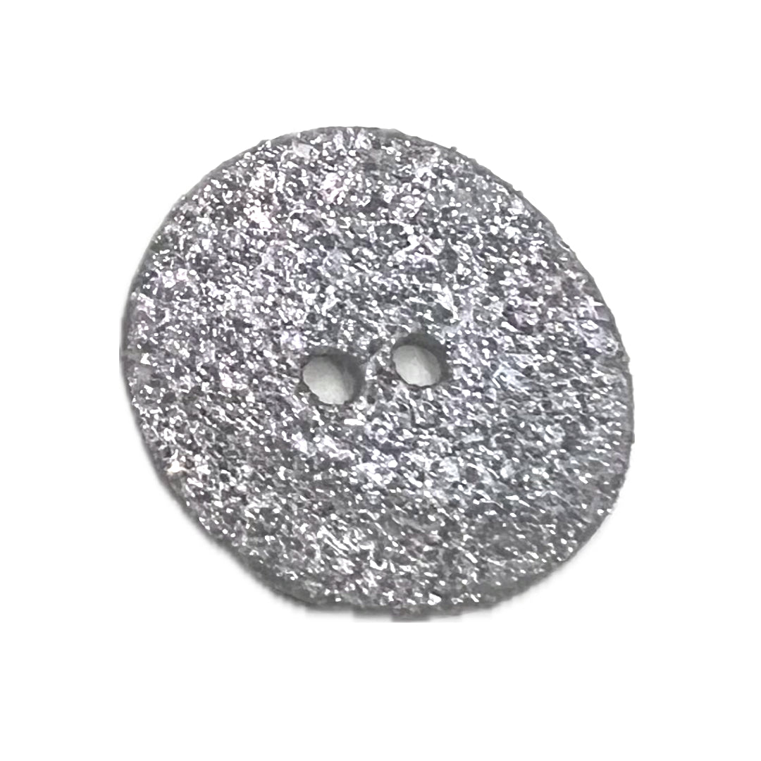 Shell button with 2 holes and glitter attached on the front. 