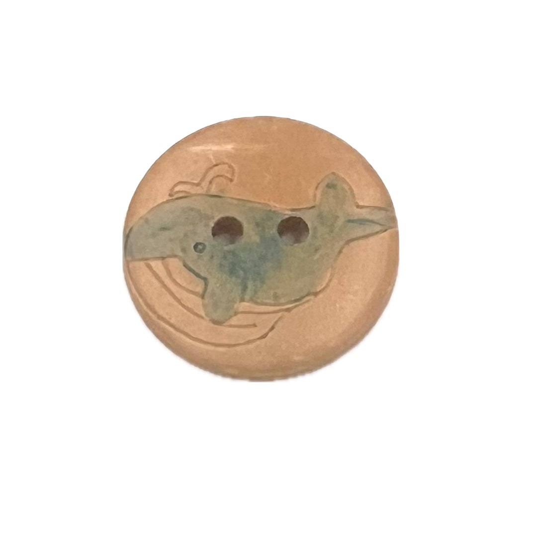 2 holed, wooden button with the shape of a baby dolphin.