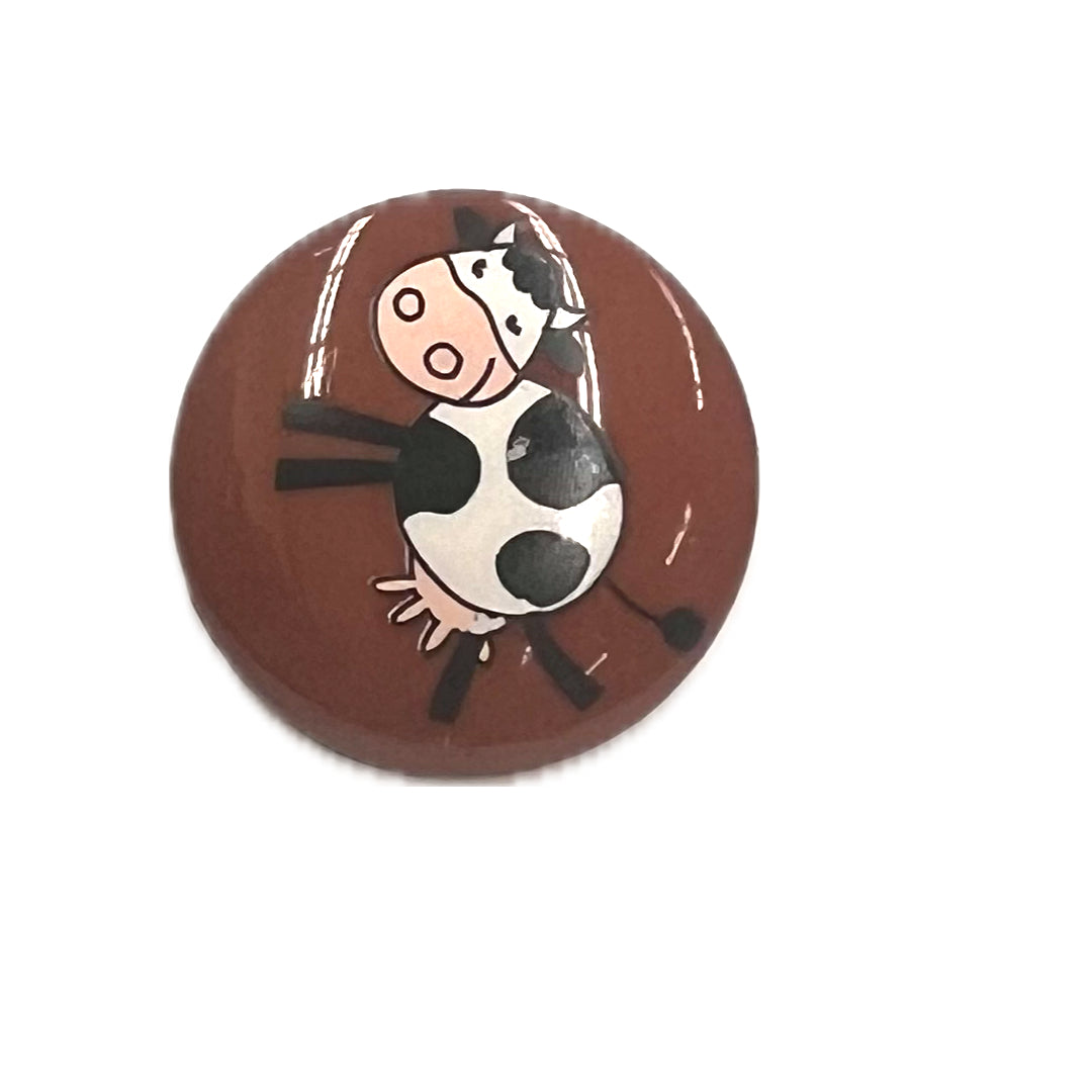 Brown plastic shank button with a cartoon cow on it.
