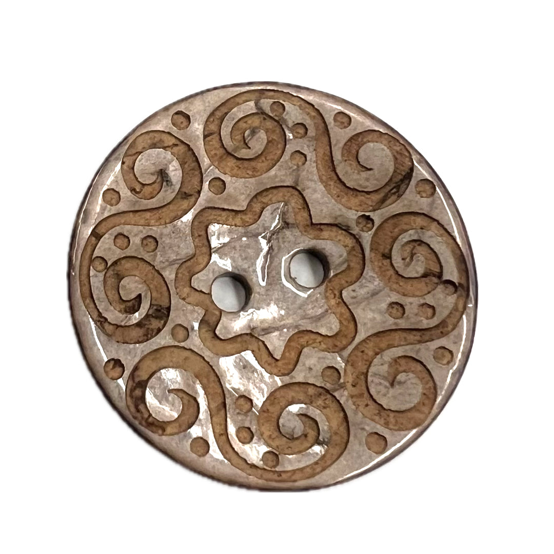 2 holed button with spirals carved into it. 