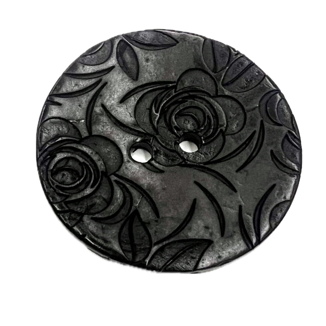 2 holed button with roses carved into it.