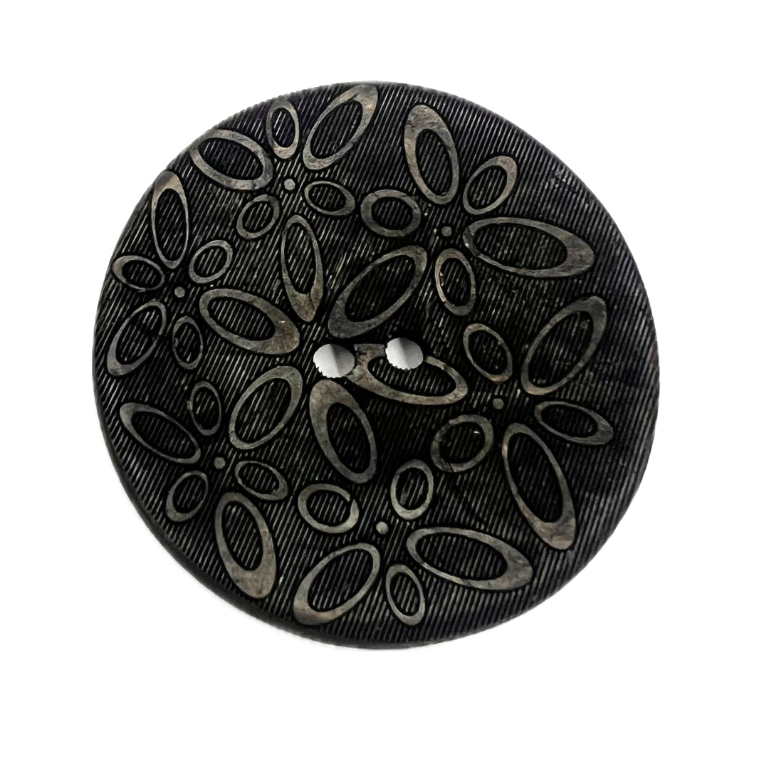 2 holed button with ovals carved into the face of it.