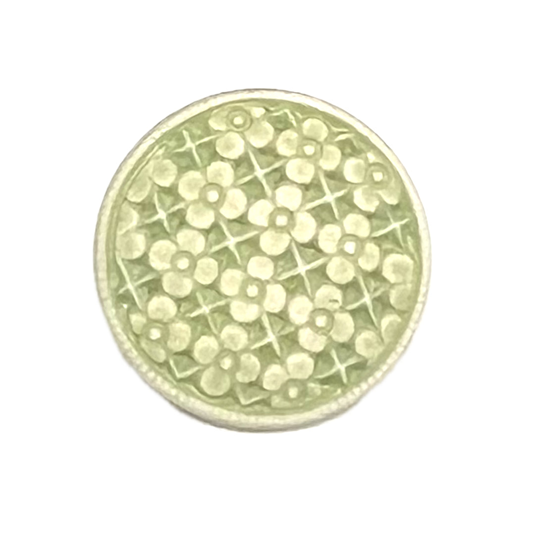 Green button with flowers on it. 
