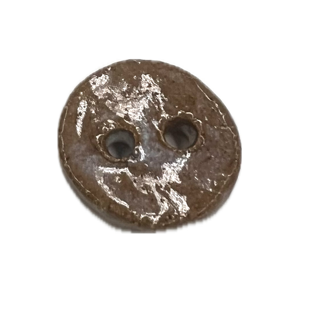 Ceramic button with a light glaze and 2 holes.