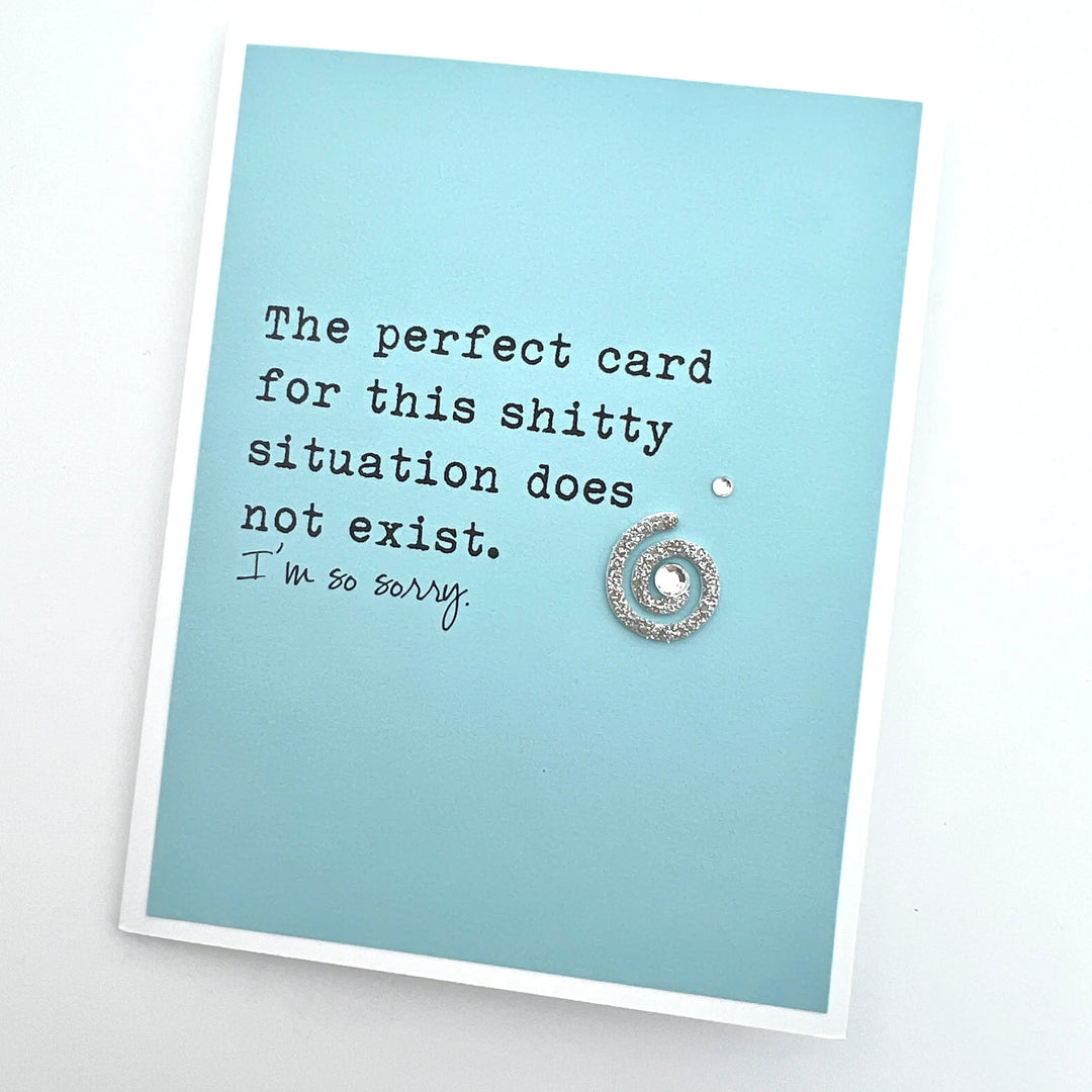 Sparkly Spiral, and jewel on a blue card that says, "The perfect card for this shitty situation does not exist. I'm so sorry."