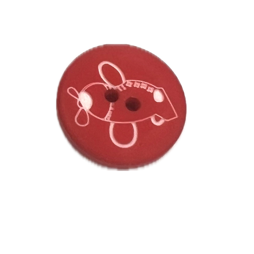 Plastic button with 2 holes with a simple airplane drawn on it. 