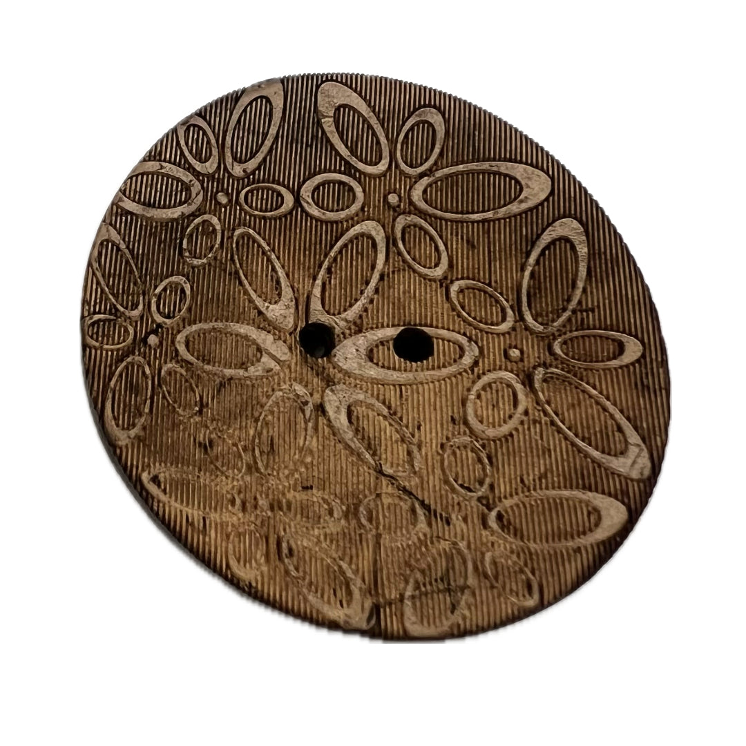 2 holed coconut button with ovals carved into it. 