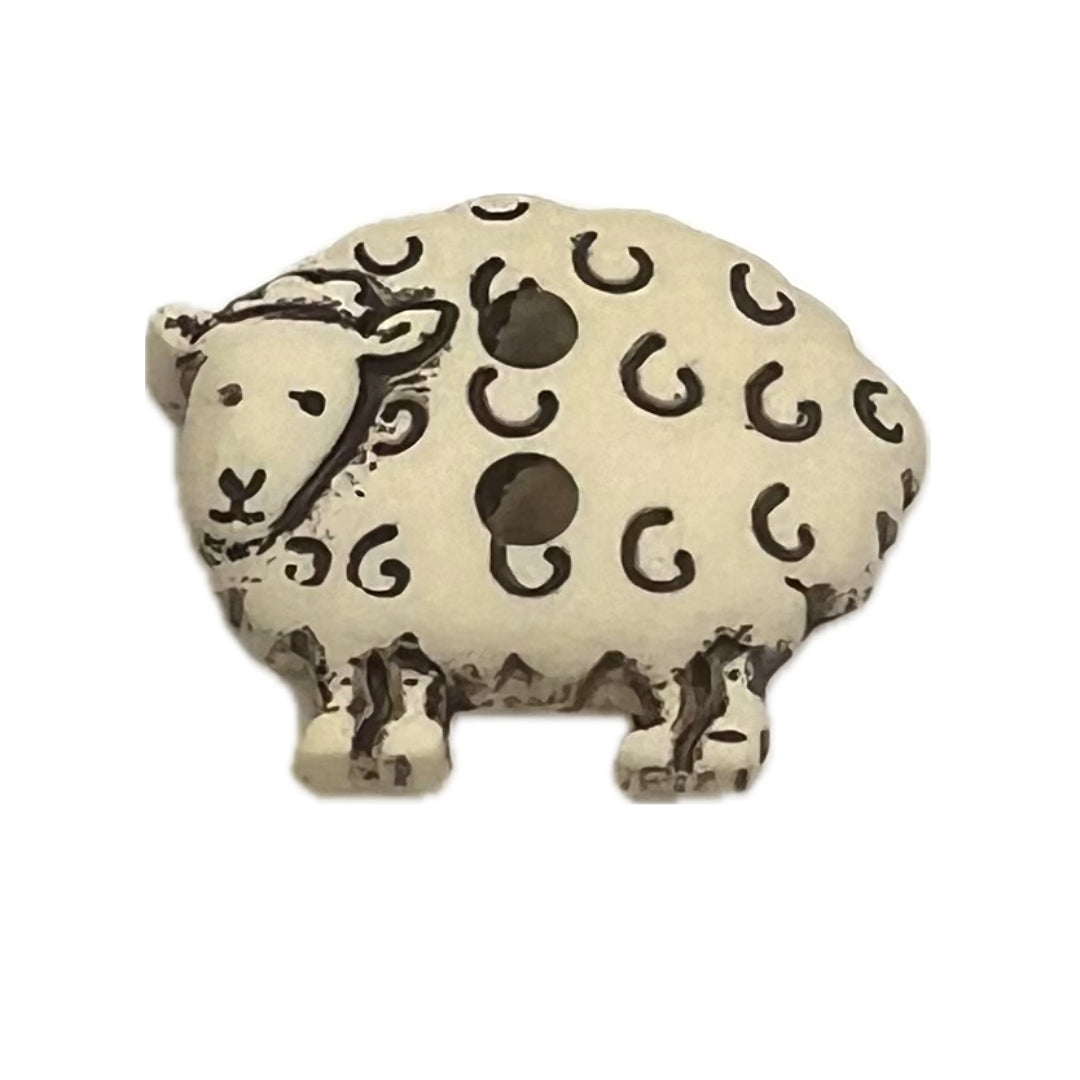 Plastic sheep shaped button with 2 holes.