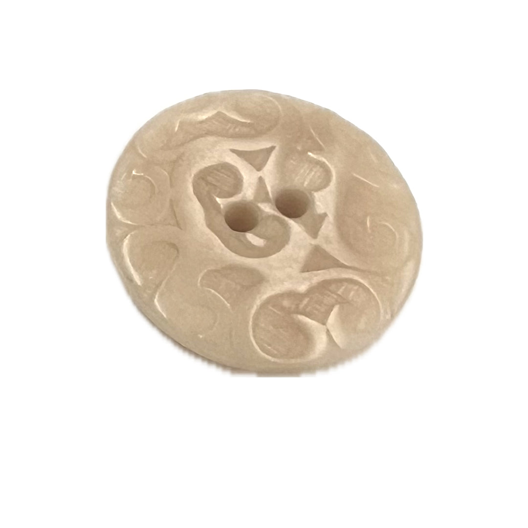 Round, ornate button with 2 holes.