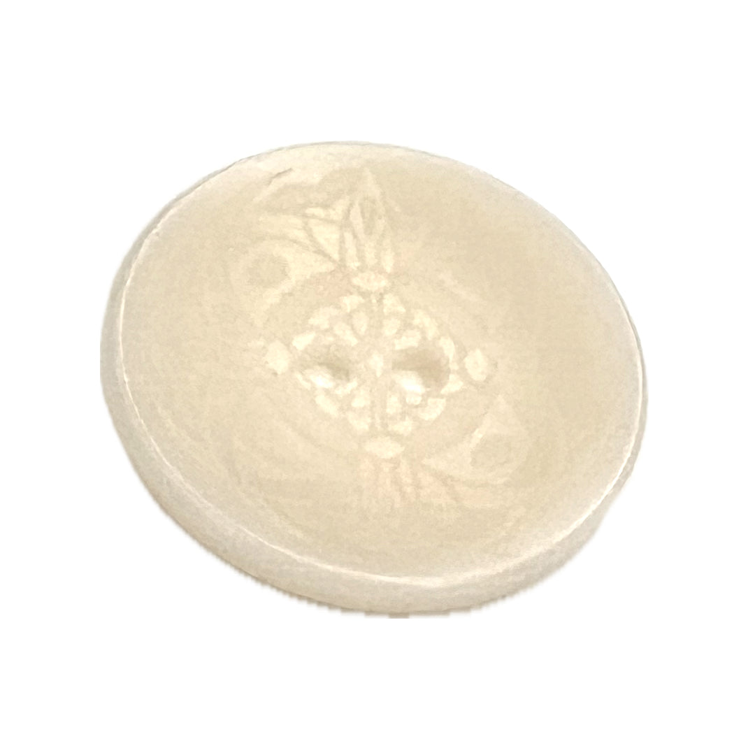 Button made from a Tagua nut with a mandala-like etching on it with 2 holes.