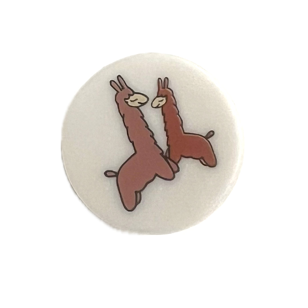 Shank button with 2 cartoon llamas on it.