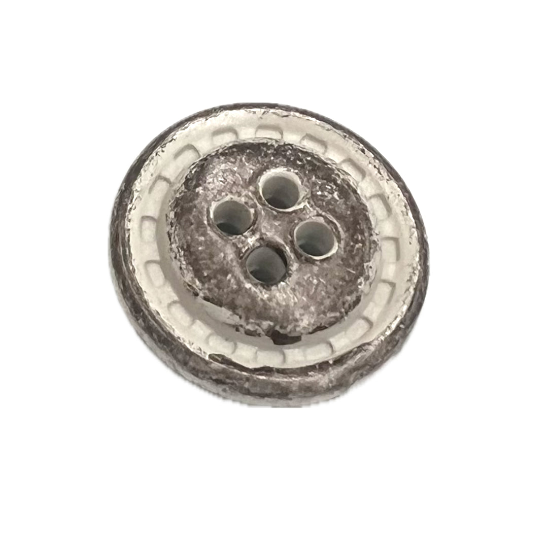 gray/brown button with 4 holes and a white edge. 