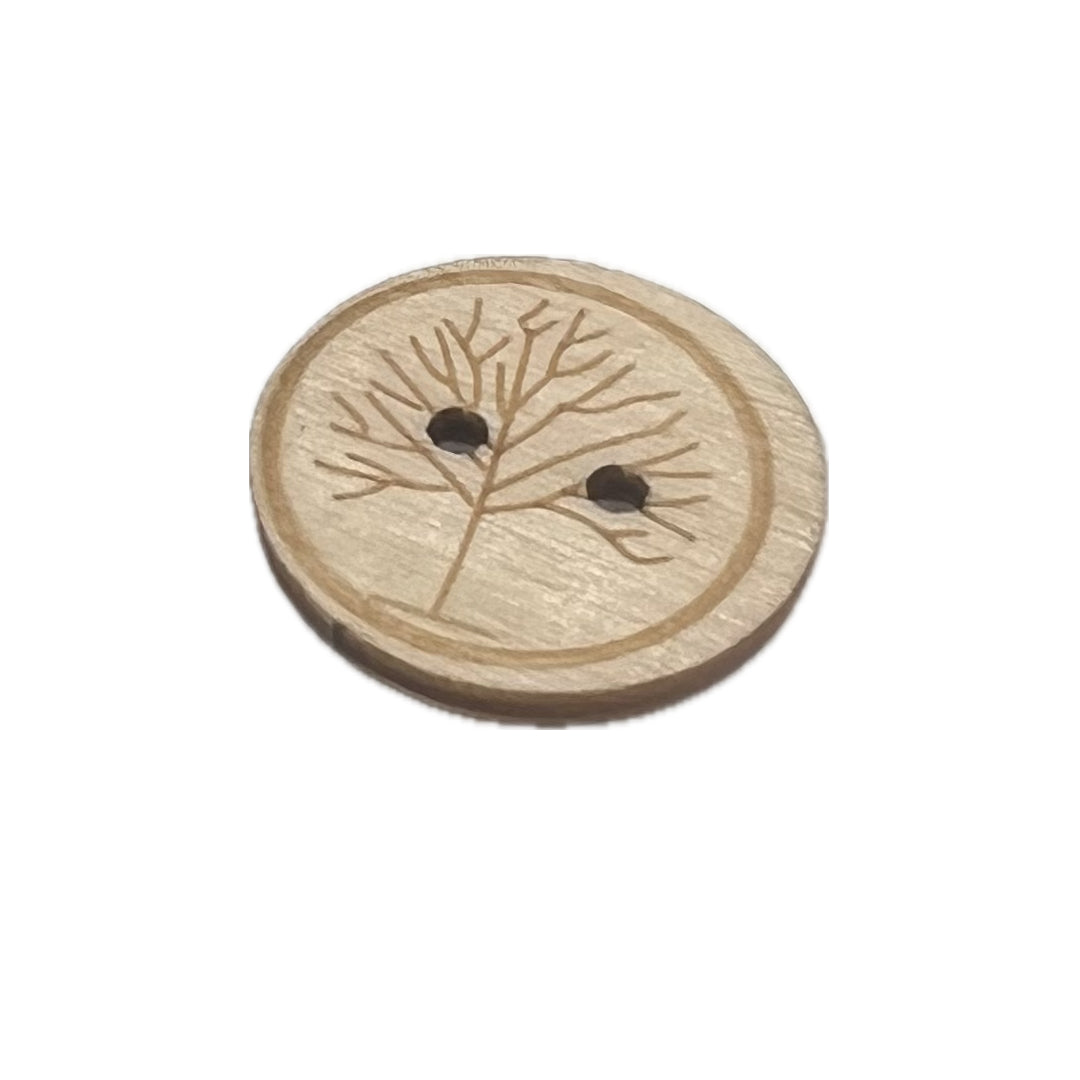 Wood button with an off center tree 