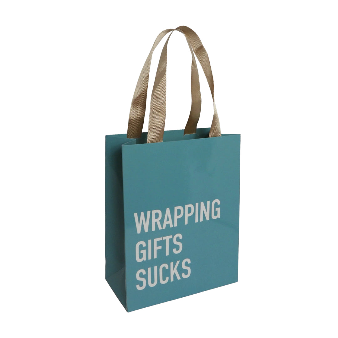 Teal gift bag with beige handles. The bag reads," WRAPPING GIFTS SUCKS"